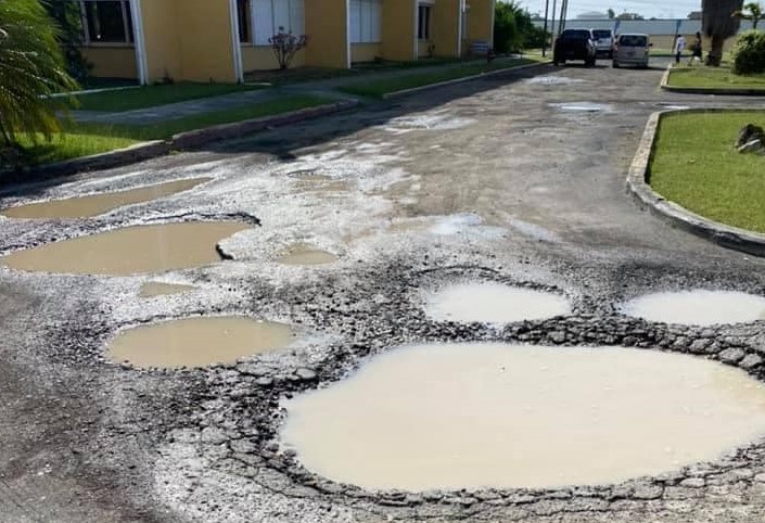 DINO PRINT! Potholes At Department of Finance St. Croix Large Enough To Swallow A Car Whole!