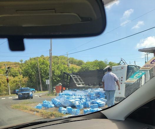 Delivery truck hauling water bottles overturns on Miracle Mile in St. Croix