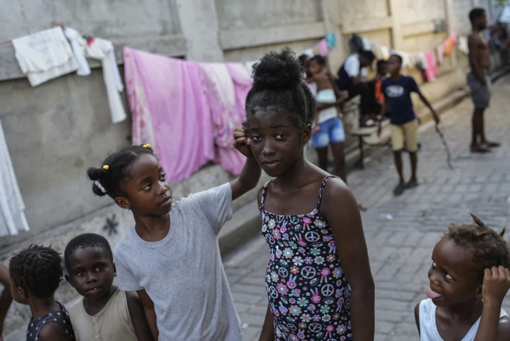 Forced to rebuild a life at 12, a Haitian girl joins thousands seeking an escape from gang violence