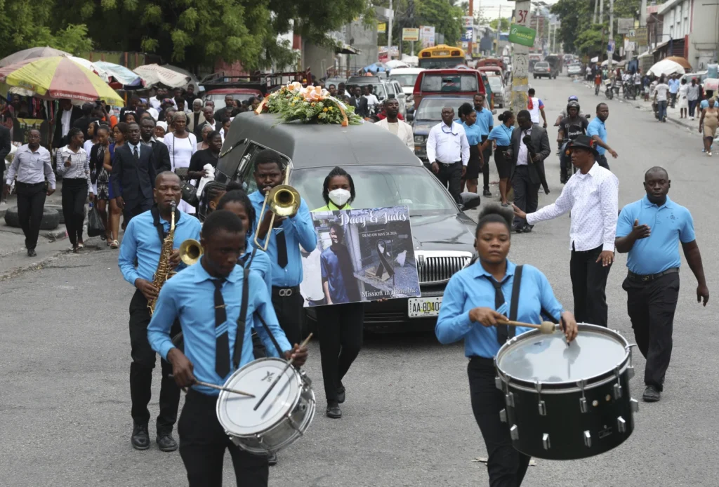 Hundreds mourn gang killings of a Haitian mission director and a young American couple