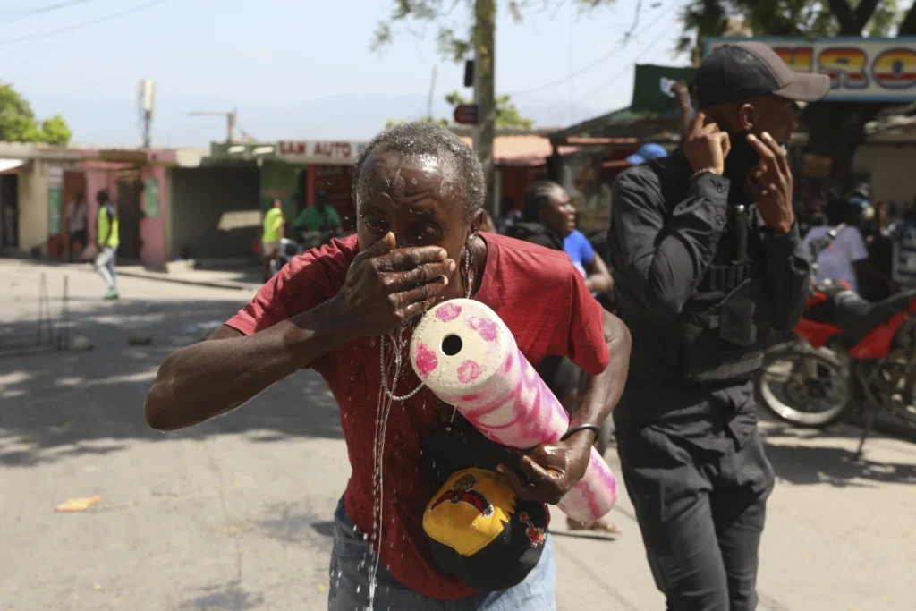 Haitian police tear-gas peaceful protesters as they demand help in stopping gangs