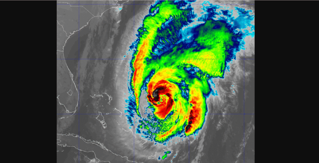 A mix of sun and clouds with a passing shower, high 90